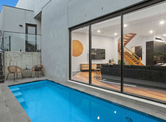 Courtyard swimming pool at dusk with glass sliders, Avoca Beach